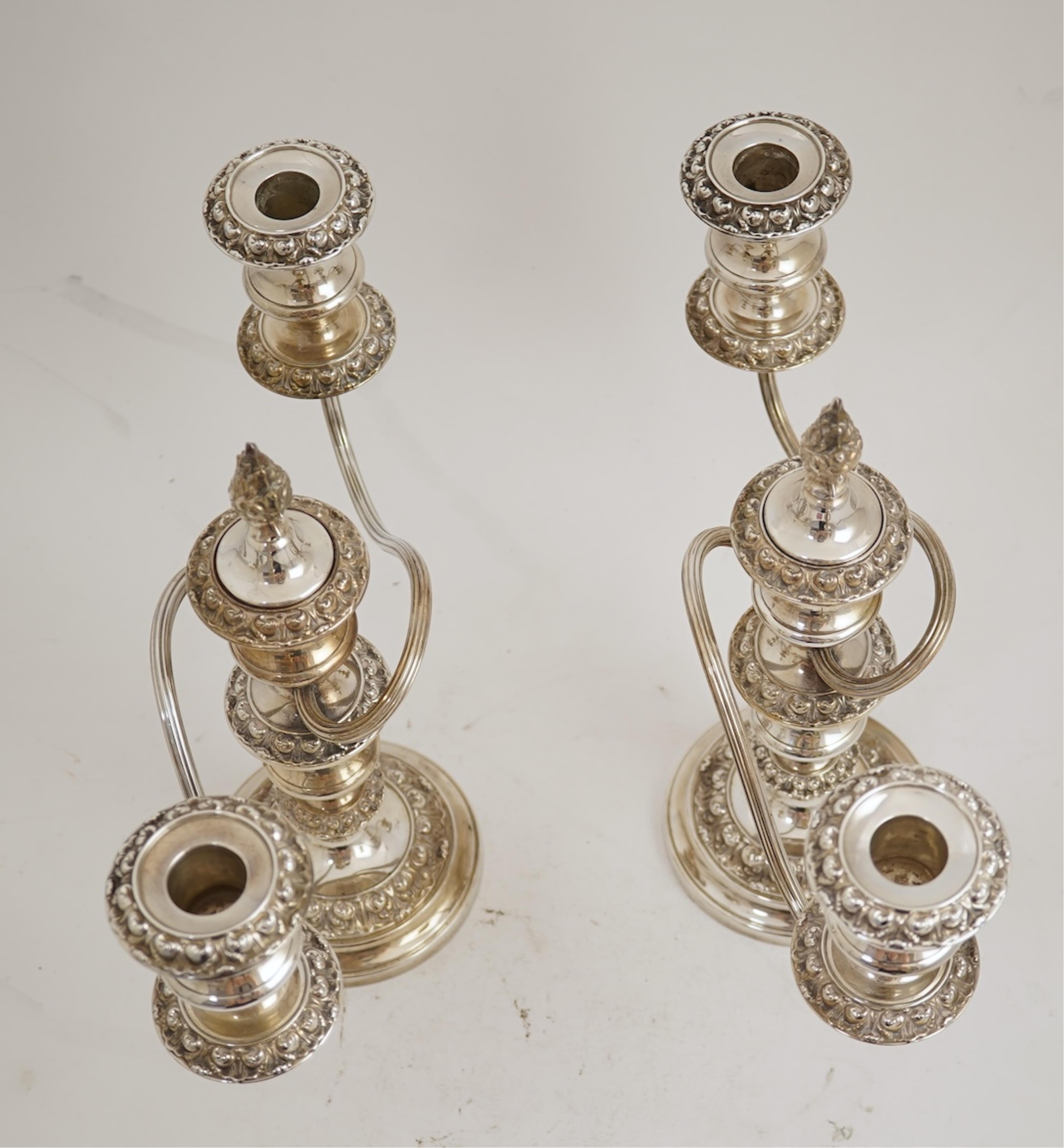 A pair of Elizabeth II silver dwarf two branch, three light candelabra by Barker Brothers Silver Co, with scroll arms and turned knopped stems, Birmingham, 1960, weighted, arms 52oz.
